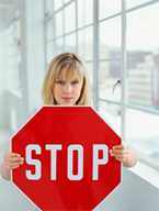 A woman holding up a stop sign