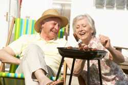 Elderly couple with a grill
