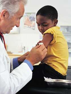 Photo: child being immunized by a physician.