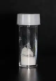 White powder in a stoppered glass vial