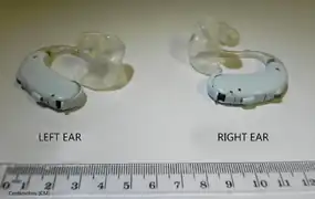 Pair of BTE hearing aids with earmolds.
