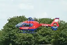 Red and blue helicopter flying