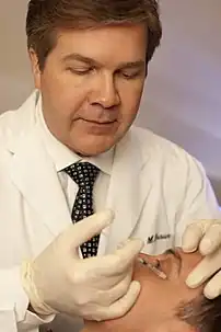 Botulinum toxin being injected in the human face