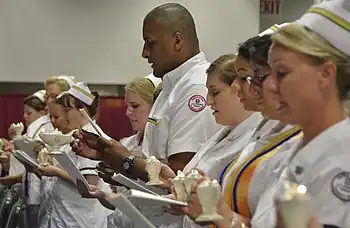 Nursing student graduate Luis Figueroa (center) participates in the reading of the International Nurses' Pledge during Germanna Community College's Nursing and Health Technologies convocation, held at the Fredericksburg Expo and Conference Center in Fredericksburg, Virgina, USA.