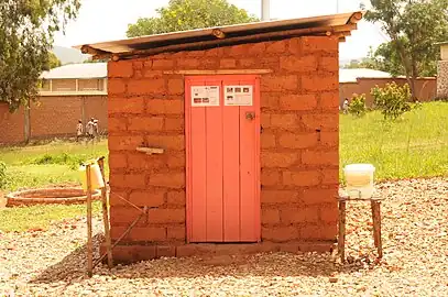 Improved sanitation example: pit latrine with a slab covering the drop hole and handwashing station in Burundi