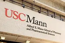 A sign on the wall that reads USC Alfred E. Mann School of Pharmacy and Pharmaceutical Sciences