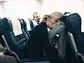 Person sleeping in plane in travel pillow