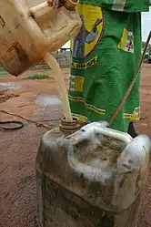 A woman is filling a jerrycan with unsafe drinking water at the Boromata well in Central African Republic.