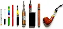 Displaying a variety of e-cigarettes standing next to each other. It includes an e-cigarette designed to look like a tobacco cigarette, an e-cigar, and an e-pipe.