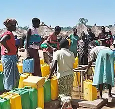 Women line up at a bore hole to fill their containers with water (Labuje IDP camp, Kitgum, Kitgum District, Northern Region of Uganda)