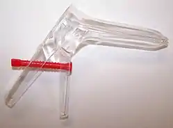 Photograph of a transparent speculum on a white surface