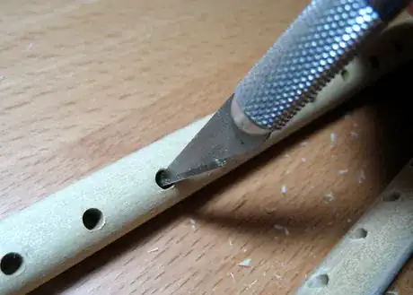 Image titled Clean up the holes and do any sanding.