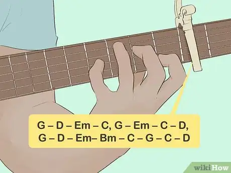 Image titled Man playing the guitar with common chord progressions written out.