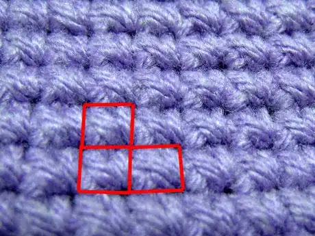 Image titled Two stitches in one row and one in the next. The rows are horizontal in this photo.
