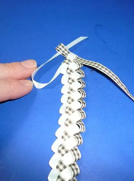 Image titled Slide one ribbon end through the existing loop to tie off.