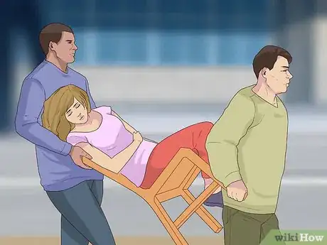 Image titled Carry an Injured Person Using Two People Step 11