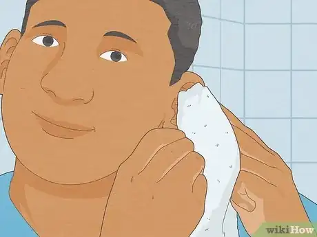 Image titled Remove Water from Ears Step 1