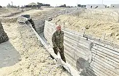 Aliyev walking through the trench