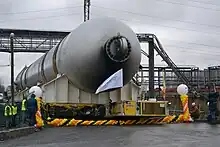 Large metal cylinder being transported