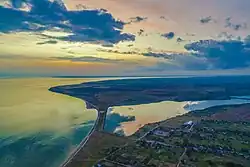 The western edge of the village (foreground), the Dnieper–Bug estuary (left) and lake (center right)