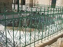 Closeup of the pool, enclosed by green banisters (handrails)