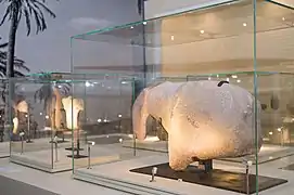 A large ancient stone carving, dating back to 8100 BC, of an equid—an animal belonging to the horse family, found at Al-Magar. The piece itself, measuring 86 cms long by 18 cms thick and weighing more than 135kg., is a large sculptural fragment that appears to show the head, muzzle, shoulder and withers of a horse.