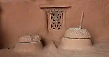 A quern-stone (right), known as jato in Nepali, in the porch of a rural Nepali house.