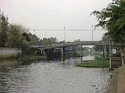 Nameless bridge crossing canal in front of Wat Phosop Phon Charoen, Khu Khot, Lam Luk Ka