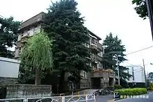 Old building with trees in front