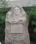 A stone statue in front of the student dormitory of Qingdao Tourism School, China