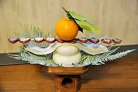 Japanese kagami mochi served with dried persimmon-skewers