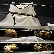 Black lacquered hanamaru mon maki-e raden daishō koshirae (sword mounting). Meiji period.