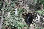 A statue and waterfall in the complex (2022)