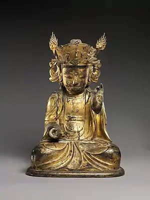Seated bodhisattva (left attendant of a triad)