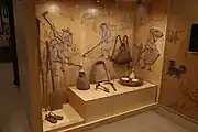 An exhibit in the museum showing various Korean agricultural tools, including a winnowing basket (2016)