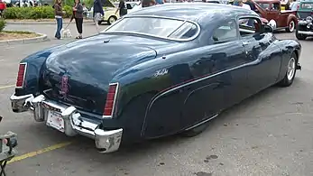 Custom Merc with pinstriping, skirts, 1981 Lincoln taillights, and Appletons