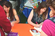 Johnson, at right, along with fellow author Lauren Myracle at left while signing at the LA Times Festival of Books in 2012.