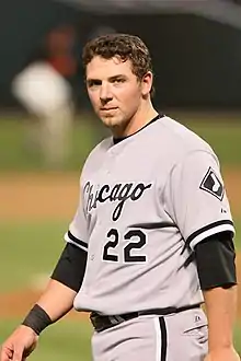 A baseball player in a gray jersey and pants