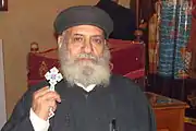 Coptic priest holding a hand-held blessing cross (Cairo, 2010)