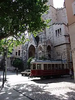 Tram 21 near Sóller Mercat stop, passing close to the church of San Bartolomé