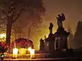 All Saints' Day at a cemetery in Sanok—flowers and lit candles are placed to honor the memory of deceased relatives.