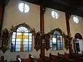 Side wall with the stained windows and religious images (prior to the 2020 fire)