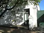 This historic dwelling-house is a typical double-storeyed town house of the second half of the 19th century. The property forms an essential part of the traditional architectural street scene of Dorp Street, and thus also of the historic core of Stellenbosch.