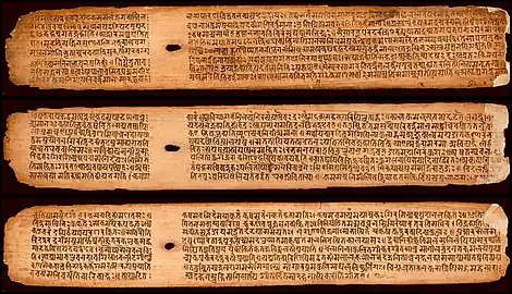 A few palm leaves from the Buddhist Sanskrit text Shisyalekha composed in the 5th century by Candragomin. Shisyalekha was written in Devanāgarī script by a Nepalese scribe in 1084 CE. The manuscript is in the Cambridge University library.
