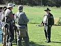 A park ranger speaks to reenactors at the park, 2012
