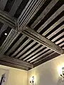 The hall: heavily moulded beams of the ceiling of the small room to the south of the hall.