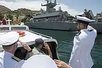 Adm. James G. Foggo III, commander, U.S. Naval Forces Europe-Africa and commander, Allied Joint Force Command Naples, Italy, returns a salute from crewmembers aboard Hellenic Navy Roussen-class fast attack craft HS P-71 Ritsos as he arrives at a Salamis Naval Base in Greece, May 10, 2018