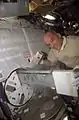 NASA Image: ISS013E64641- Astronaut Jeff Williams, Expedition 13 ISS Science Officer, places a POEMS sample into the MELFI freezer (Minus Eighty Laboratory Freezer for ISS).
