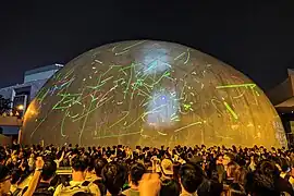 Protesters shining laser lights on the exteriors of the Hong Kong Space Museum, August 2019
