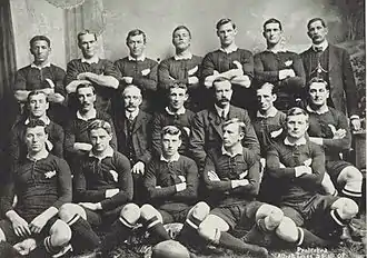 Photo of a group of rugby players posing in their uniforms.